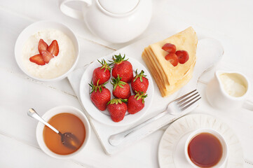 Strawberries and pancakes. Pancakes with strawberries. Romantic breakfast. Valentine's Day. Greeting Card Mother's Day. Breakfast in hotel room. Maslenitsa. Pancake week. Women's Day Congratulation