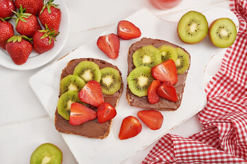 Fruit Sandwich, strawberries and kiwi. Peanut Butter Toast. Creative idea for kids breakfast, dessert or holiday meal, top view flat lay, healthy food for children. Good morning. Sweet breakfast