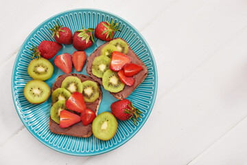 Fruit Sandwich, strawberries and kiwi. Peanut Butter Toast. Creative idea for kids breakfast, dessert or holiday meal, top view flat lay, healthy food for children. Good morning. Sweet breakfast