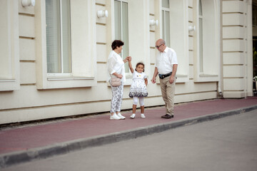 Grandparents playing with their granddaughter