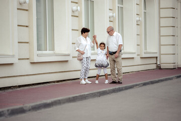 Grandparents playing with their granddaughter