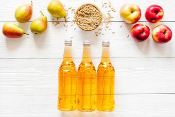 Set of beer bottles with apple, pears, wheat top-down