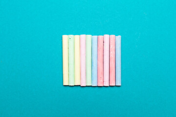 Colors chalk sticks on blue background 