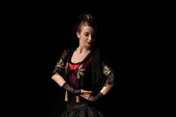 attractive dancer in dress dancing flamenco isolated on black