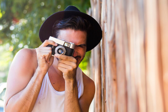 Hipster young man with vintage camera outdoors - Powered by Adobe
