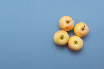 Four apples isolated on blue background 