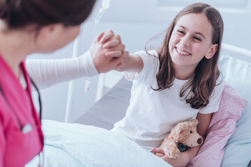 Professional doctor supporting her sick child patient