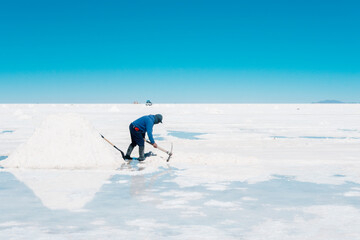 Reflection in the water of a local Bolivian man working in the S