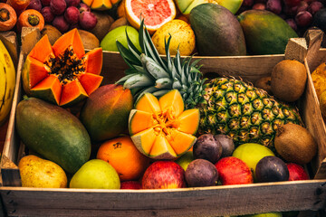 fruit background. boxes with fruit. variety of tropical fruits. summer enjoyment of fruit