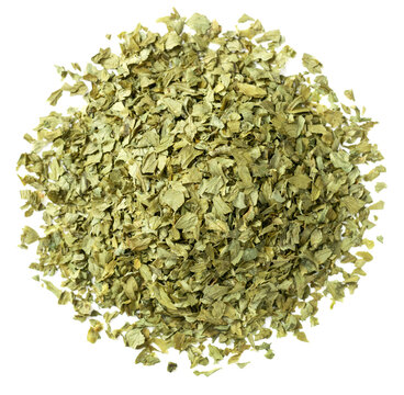 heap of dried parsley flakes isolated on white background, top view