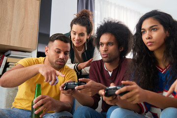 Friend giving instructions while playing on the console