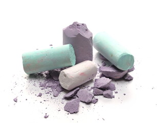 Multiple broken colorful chalks isolated on white background