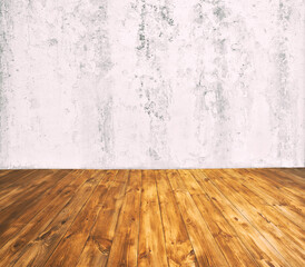 The room with gray cercement wall and wooden floor with lots of planks