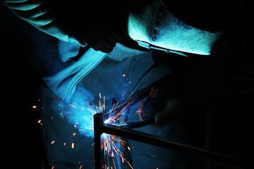 Sparks from welding. A man will weld metal. Workplace of the welder. Garage welder