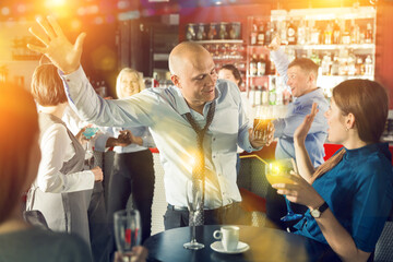 Man in unbuttoned shirt at corporate party