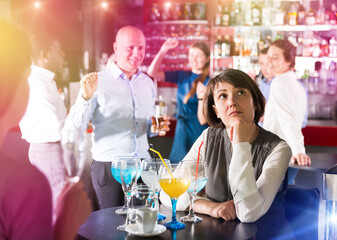 Woman bored at corporate party