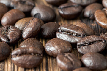 Close-up of coffee beans on dark wooden background. Selective focus