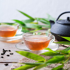 Cup of hot green tea on a wooden table