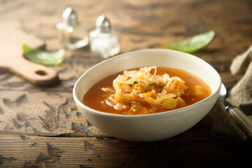 Traditional homemade sauerkraut soup in a white bowl