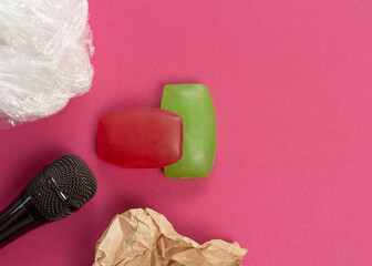 ASMR concept. Specific auditory irritants. Soap, plastic wrap and wrinkled paper lie in front of the microphone. Top view, flat lay.