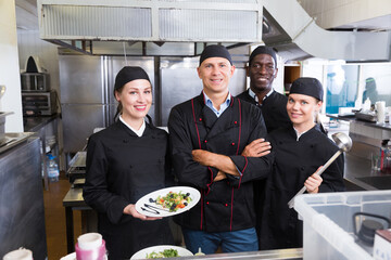 Group of chefs in kitchen of restaurant