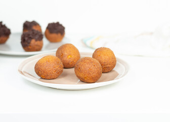 Deep fried bunuelos balls. Creative minimalist composition on a white background.