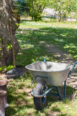 wheelbarrow and rake in the garden 