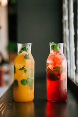 Glass jars fresh fruit lemonade on wooden table