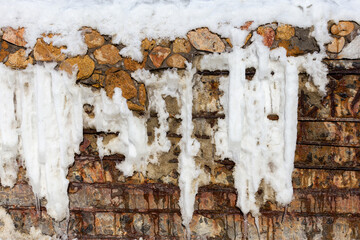 Abstract background of stone wall covered with rust and ice winter day