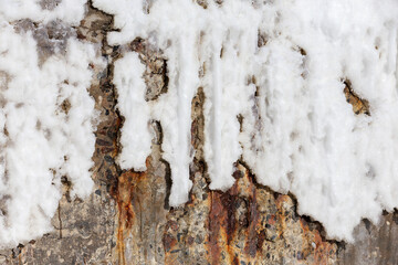 Abstract background of stone wall covered with rust and ice winter day