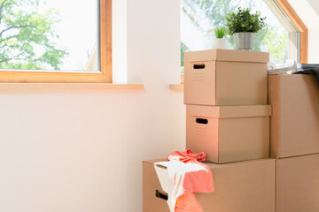 Fototapeta premium Move. Cardboard boxes for moving into a new, clean home. In a sunny day by a window in attic.