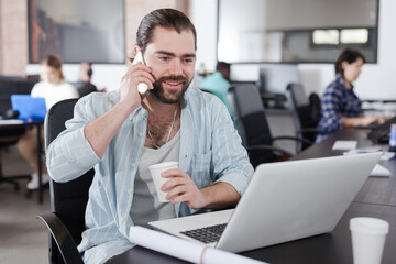 Happy freelancer having phone call conversation
