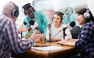 Radio hosts interviewing guest