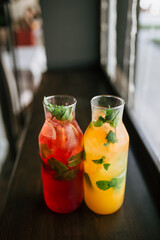 Top view on glass jars with fresh fruit lemonade