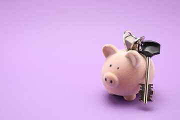 piggy bank with key for apartments isolated on color background 
