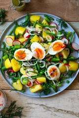 Summer salad with potatoes, green beans, asparagus, peas and radishes