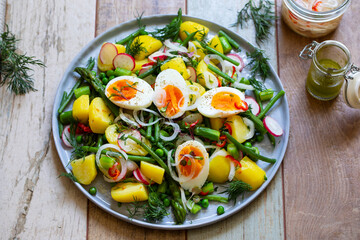 Summer salad with potatoes, green beans, asparagus, peas and radishes