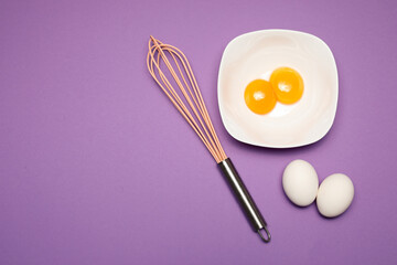 Cracked egg on purple background