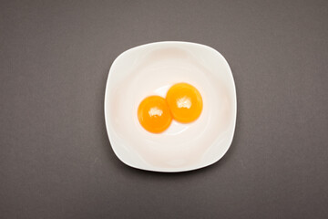 Cracked egg on gray background