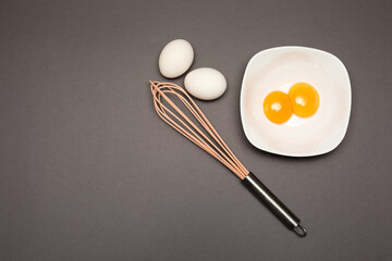 Cracked egg on gray background