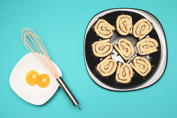 Roll cake on the plate and eggs