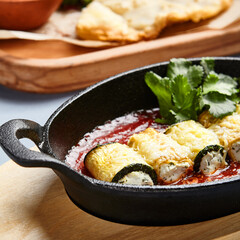 Eggplant rolls with cheese in tomato sauce