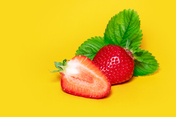 Strawberries with leaves. On a yellow background.