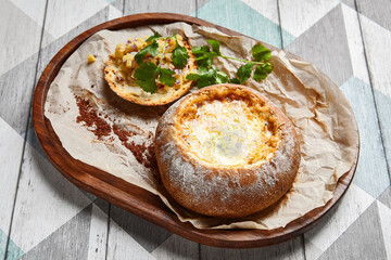 Cheese soup served in round bread loaf