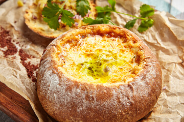 Cheese soup served in round bread loaf