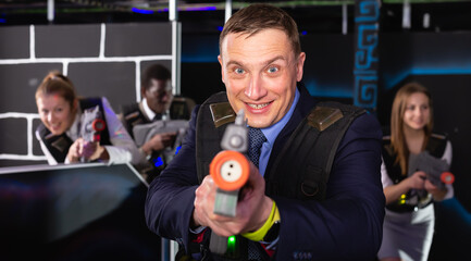 Jolly  man and his colleagues in laser tag room