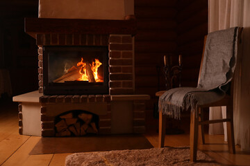 Fireplace with burning wood indoors. Winter vacation