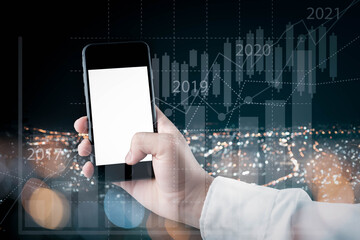 businessman holding mobile phone with social network icon ,Businessman holding and use the mobile phone to check the stock marketing information around the world Highest stock price and diagram.