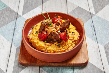 Hummus with beef served in brown bowl