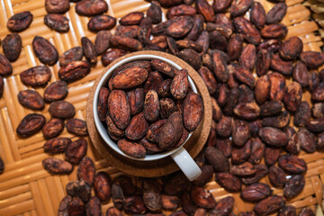 Top view of A lot of Cocoa bean in cap  and put on the wooden table